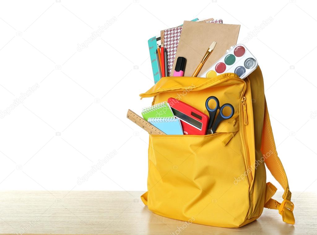 Yellow school backpack isolated on white