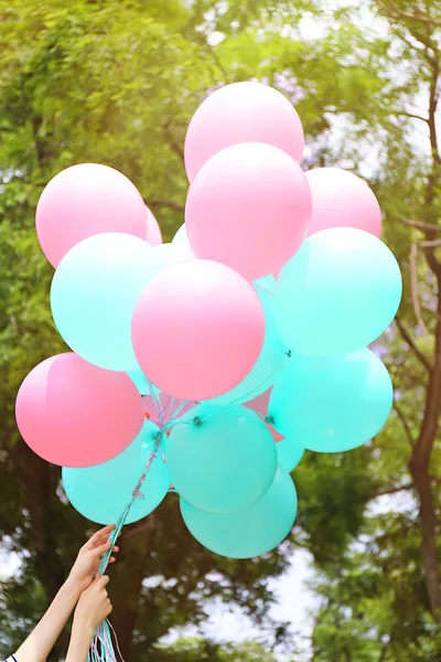 Holding colorful balloon — Stock Photo, Image