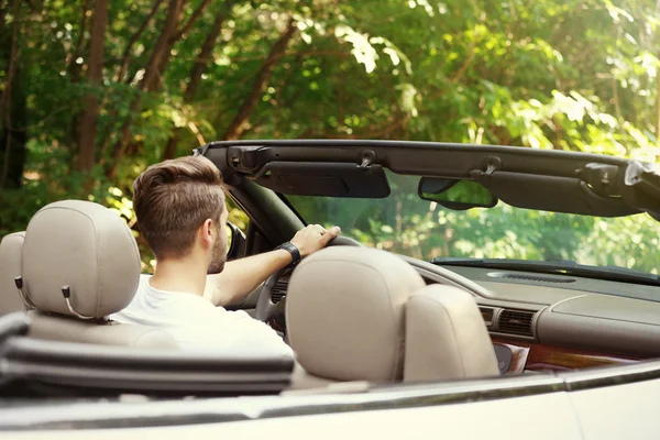 Man driving car on road trip