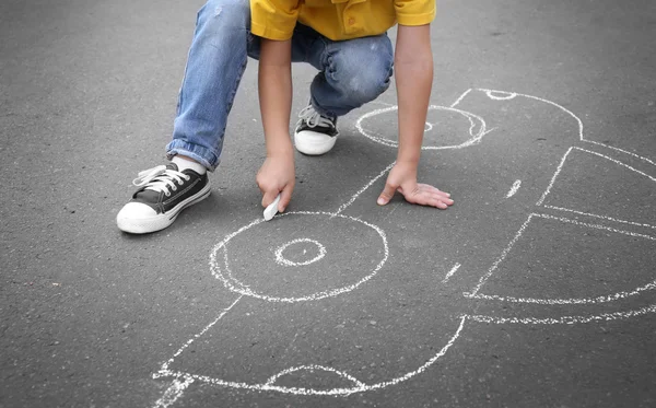 Boy with chalk drawing car — Stock Photo, Image