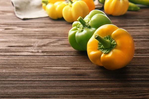 Fresh peppers on wooden table — Stock Photo, Image