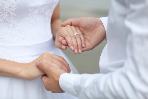 Bride and groom holding hands