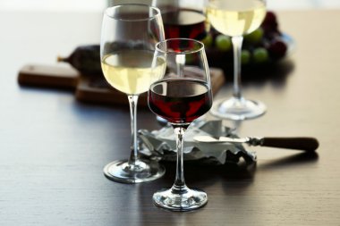 Glasses with wine on served table clipart