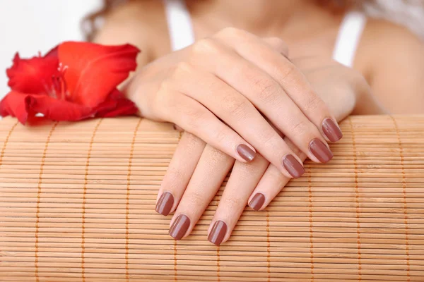 hands with brown manicure