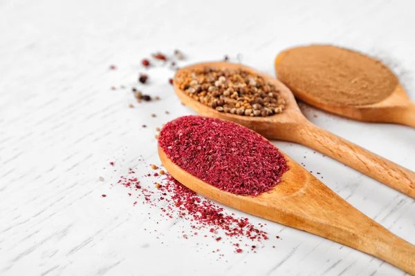 Spices in wooden spoons — Stock Photo, Image
