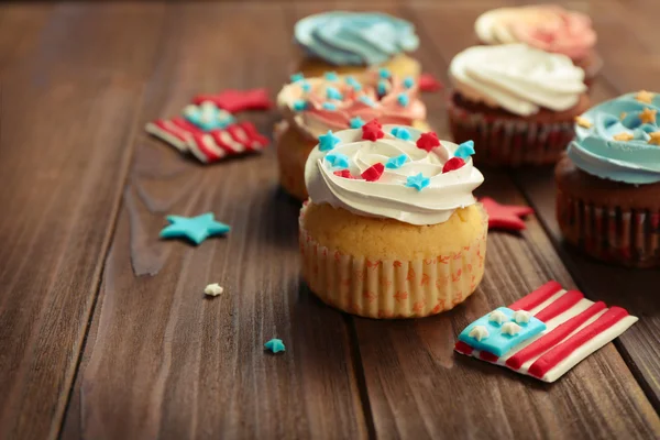 Delicious cupcakes on wooden background — Stock Photo, Image