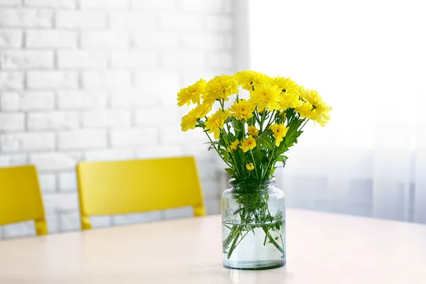 Bouquet of fresh yellow flowers on white table — Stockfoto