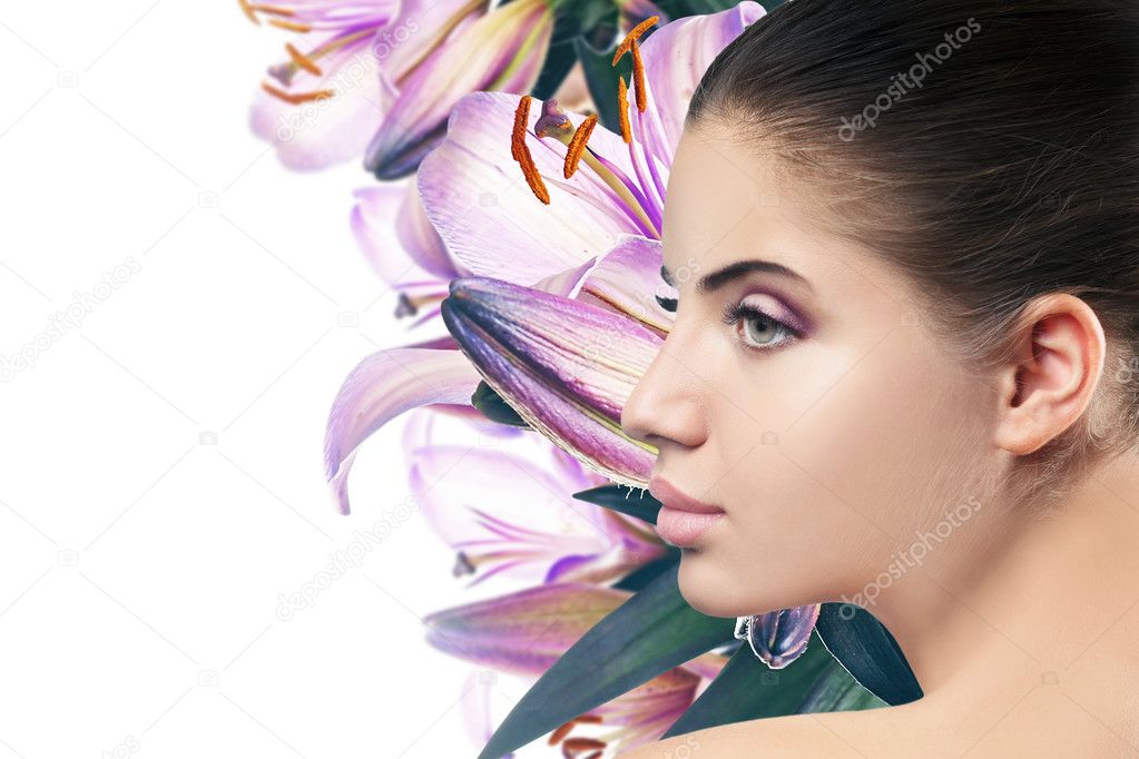 Beautiful woman with makeup on face and flowers background. Beauty concept.