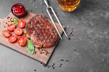 Lezzetli biftek domates ve baharat kesme tahtası üzerinde