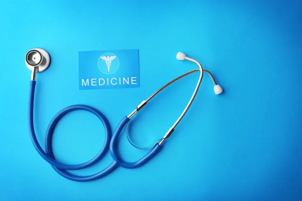 Stetoscopio e carta su sfondo blu — Foto Stock