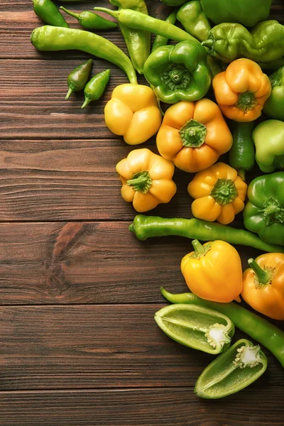 Fresh peppers on wooden table — Stock Photo, Image