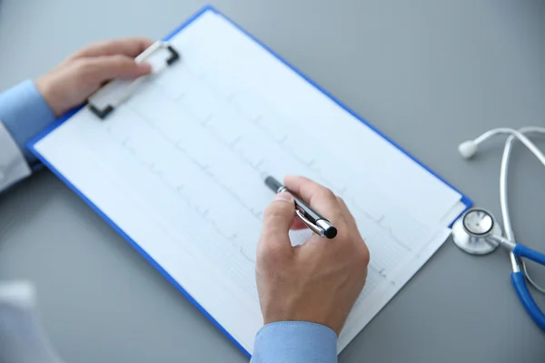 Male doctor at work in clinic office — Stock Photo, Image