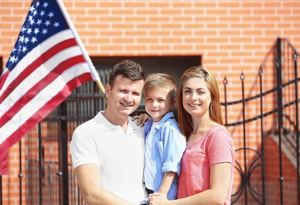 Familia feliz con bandera americana en el patio Fotos de stock libres de derechos