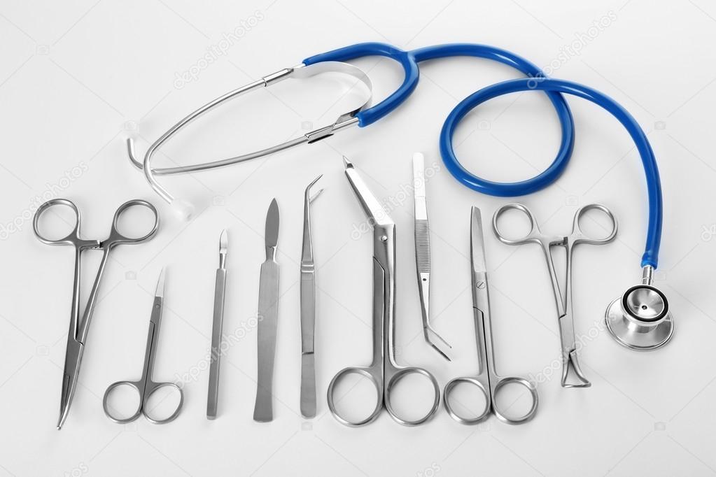 Flat lay of surgery instruments on white background