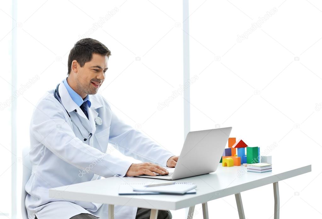Pediatrician working at his office