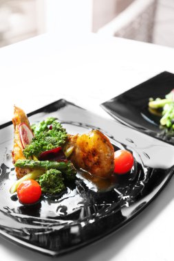 Kızarmış tavuk fileto siyah plaka üzerinde sebzeli