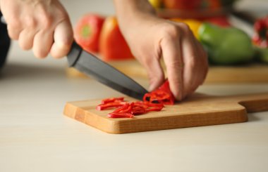 Woman cutting pepper  clipart