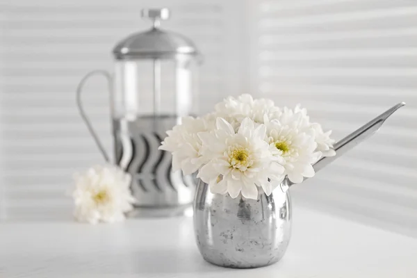 Bouquet of beautiful flowers in a jug on a  table — Stock Photo, Image