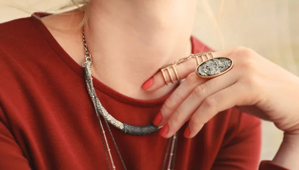 Female hand with beautiful accessories holding necklace, close up — Stock Photo, Image
