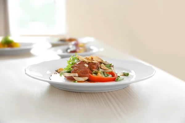 Platen met smakelijke gerechten op de keukentafel, close-up — Stockfoto