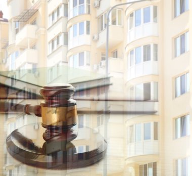 Gavel on blurred house background clipart