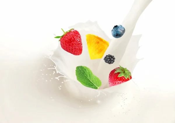 Milk splash with falling fresh tasty fruits — Stock Photo, Image