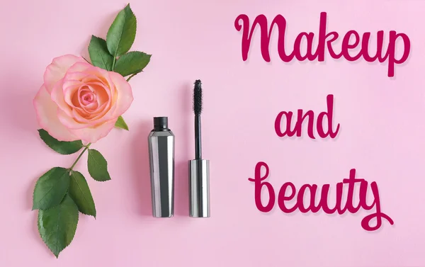 Mascara and flower on pink  background — Stock Photo, Image