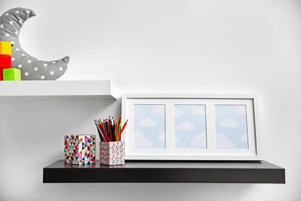 Decorative shelves on wall as detail of kid room interior — Stock Photo, Image