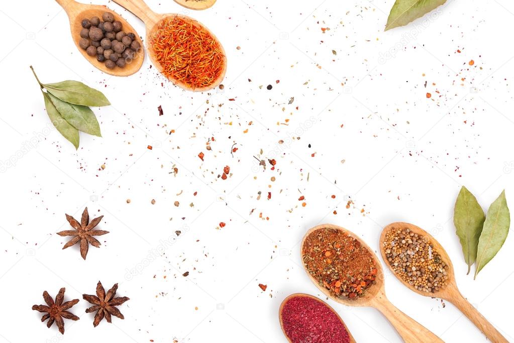 Different spices in spoons  