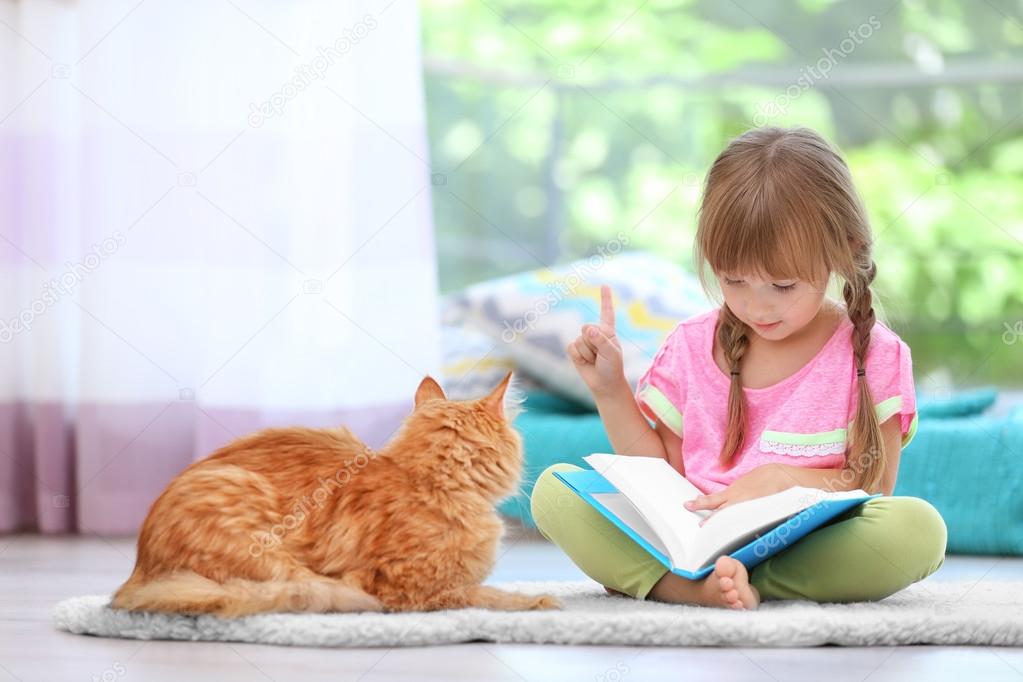 Red cat and cute little girl