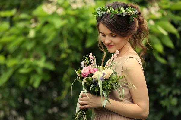 Beautiful bridesmaid holding bouquet — Stock Photo, Image