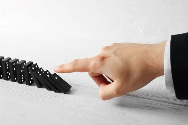 Hand pushing dominoes — Stock Photo, Image