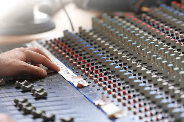 Hand on mixer in recording studio — ストック写真