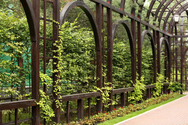 Park with wooden arches along pedestrian alley