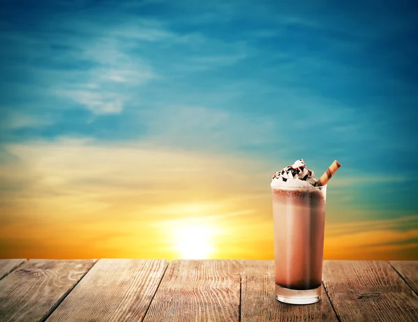 Delicious chocolate milkshake on beautiful sunset background — Stockfoto