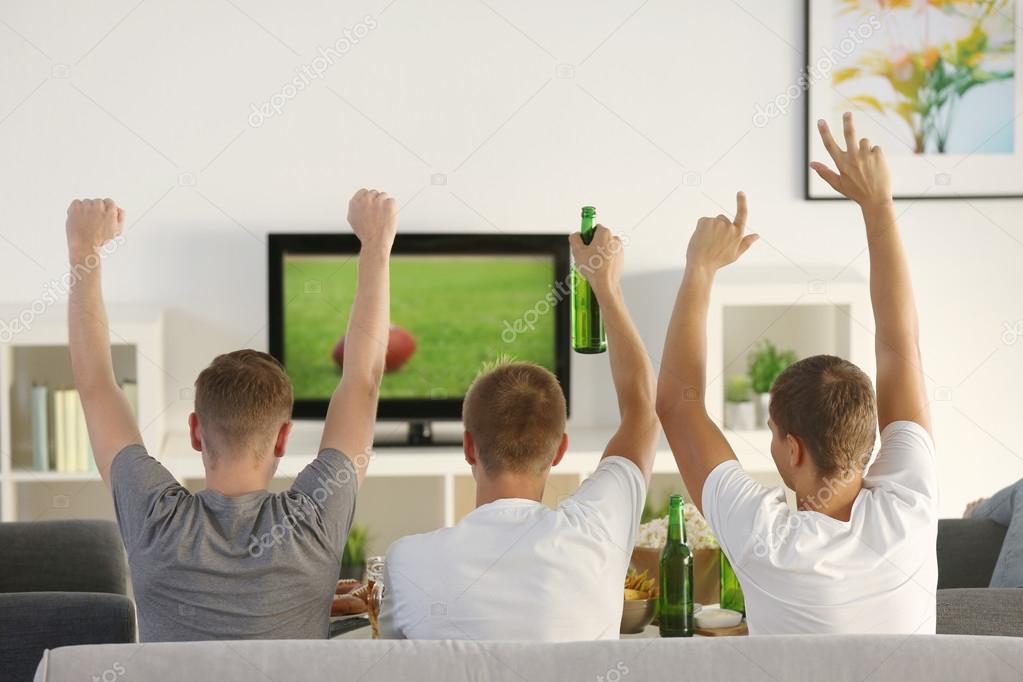 Young fans watching sports on TV