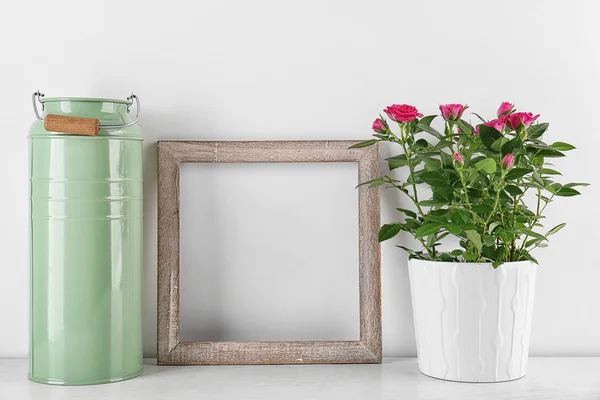 Vase with roses, watering can