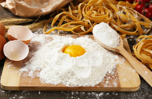 Still life with raw homemade pasta and ingredients for pasta — Stock Photo, Image