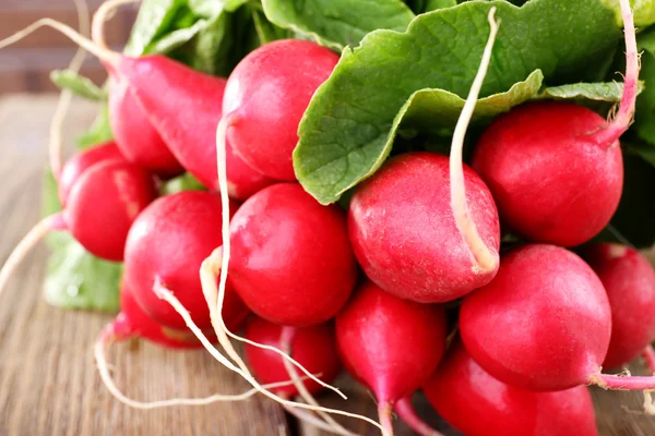 Heap of fresh radish on wooden background — Stock Photo, Image