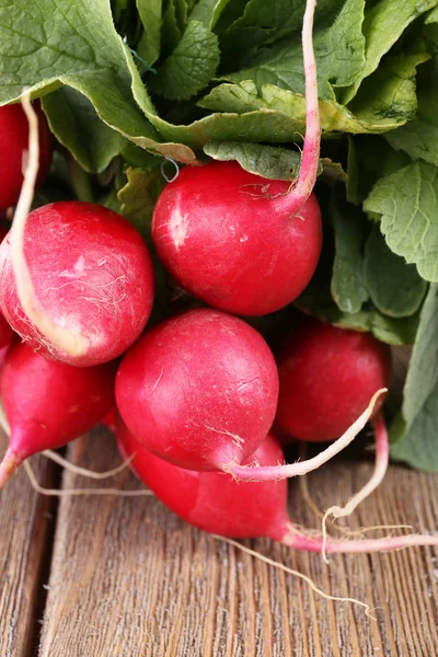 Heap of fresh radish on wooden background — Stock Photo, Image