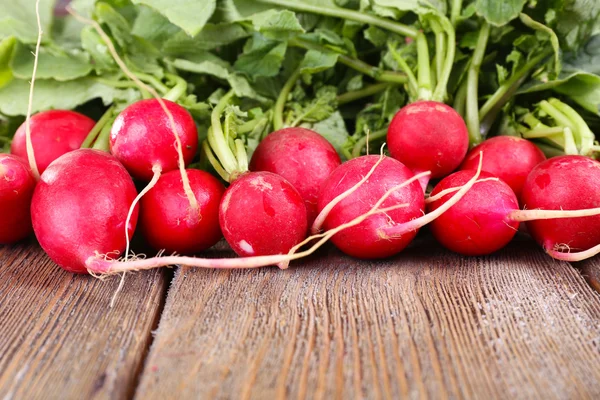 Heap of fresh radish on wooden background — Stock Photo, Image