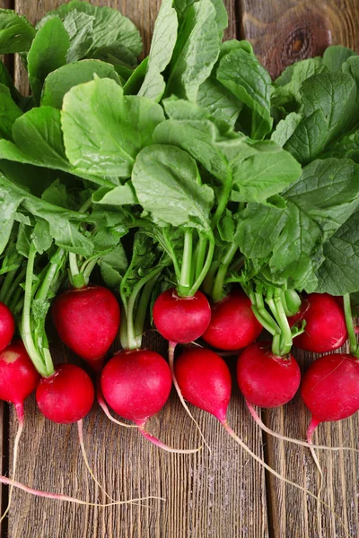 Heap of fresh radish on wooden background — Stock Photo, Image