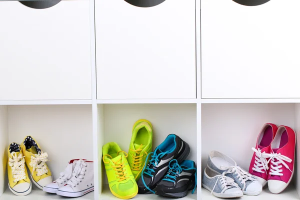 Colorful shoes on wooden shelves — Stock Photo, Image