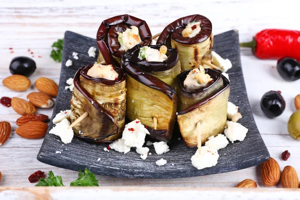 Fried aubergine with cottage cheese in a square plate on wooden background — Stock Photo, Image