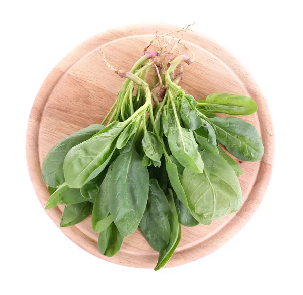 Tuft of fresh sorrel on wooden cutting board isolated on white — Stock Photo, Image