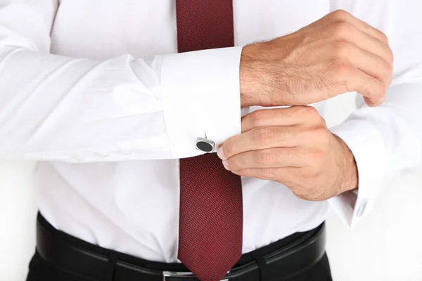 Man in white shirt doing collar button up isolated on white — Stock Photo, Image