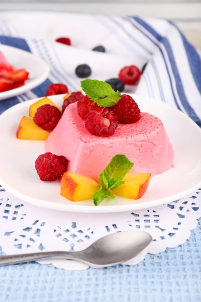 Cakes with fruit and berries on plate on lace napkin — Stock Photo, Image