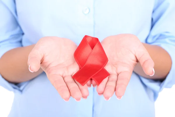 Woman with aids awareness red ribbon in hands isolated on white — Stock Photo, Image