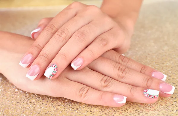 Female hand with stylish colorful nails on bright background — Stock Photo, Image