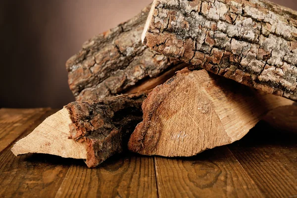 Heap of firewood on floor on dark background — Stock Photo, Image